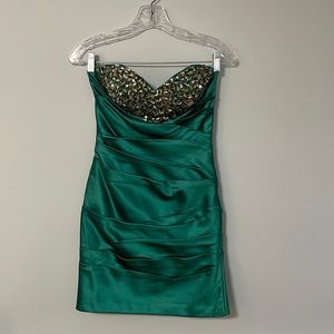Mini strapless emerald green formal dress. Beaded design on top